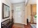 Bright entryway featuring a coat rack, mirror, and a dark wood bench on hardwood floors at 2017 Woodland Shores Rd, Charleston, SC 29412