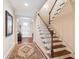 Inviting foyer with hardwood floors, a staircase with white railing, and view of the front door at 2017 Woodland Shores Rd, Charleston, SC 29412