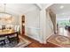 Hallway with wainscotting, hardwood floors, and a view of the dining room and staircase at 2017 Woodland Shores Rd, Charleston, SC 29412