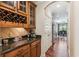 Hallway with wine storage and stainless steel refrigerator leading into the dining room at 2017 Woodland Shores Rd, Charleston, SC 29412