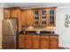 Detailed shot of kitchen cabinets, stainless steel refrigerator, and dark countertops at 2017 Woodland Shores Rd, Charleston, SC 29412