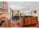 Open kitchen overlooking the dining and living areas, boasting stainless appliances and wood floors at 2017 Woodland Shores Rd, Charleston, SC 29412