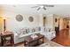 Cozy living room with a gray sectional sofa and decorative wall art and ceiling fan at 2017 Woodland Shores Rd, Charleston, SC 29412