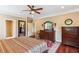 Spacious main bedroom featuring a ceiling fan, a decorative rug, and wooden furniture at 2017 Woodland Shores Rd, Charleston, SC 29412