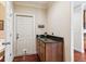 Mud room with granite countertop on cabinets, keys hanging, and a door with pet door at 2017 Woodland Shores Rd, Charleston, SC 29412