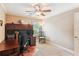 Home office featuring a ceiling fan, built-in shelves, large desk and natural light at 2017 Woodland Shores Rd, Charleston, SC 29412