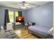This bedroom has hardwood floors, a ceiling fan, and a cozy seating area at 206 Challis Ct, Goose Creek, SC 29445