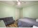 Bright bedroom featuring a ceiling fan, wood floors, and a gray futon at 206 Challis Ct, Goose Creek, SC 29445