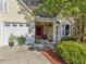 Inviting one-story home with a two-car garage, covered porch, and manicured landscaping at 206 Challis Ct, Goose Creek, SC 29445