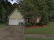 Inviting one-story home with a two-car garage, mature trees, and a well-manicured lawn at 206 Challis Ct, Goose Creek, SC 29445