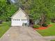 Charming one-story home with a two-car garage, mature trees, and a well-manicured lawn at 206 Challis Ct, Goose Creek, SC 29445