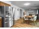 Kitchen and dining area feature stainless steel appliances, wood cabinets, and a view into the living area at 206 Challis Ct, Goose Creek, SC 29445