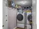 Functional laundry room featuring modern washer and dryer units, shelving, and ample storage at 206 Challis Ct, Goose Creek, SC 29445