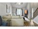 Bright living room features a large sectional sofa, wood floors, and ample natural light at 206 Challis Ct, Goose Creek, SC 29445