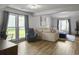 Open-concept living room with large windows, hardwood floors, and modern furniture at 206 Challis Ct, Goose Creek, SC 29445