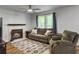 Inviting living room features a cozy fireplace, comfortable seating, and plenty of natural light at 206 Challis Ct, Goose Creek, SC 29445