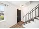 Entryway featuring a black door, stairs with black railing, and view to a window with light-colored trim at 21 Rivers Point Row # 3C, Charleston, SC 29412