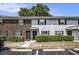 Charming exterior of townhomes with brick and gray siding, manicured shrubs, and convenient parking spaces at 21 Rivers Point Row # 3C, Charleston, SC 29412