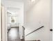 Stairway leading to rooms featuring wood floors and white walls, creating a cozy living space at 21 Rivers Point Row # 3C, Charleston, SC 29412