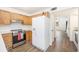 A functional kitchen with wood cabinets, stainless steel appliances, and vinyl floors at 21 Rivers Point Row # 3C, Charleston, SC 29412