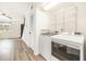 Convenient laundry area features a washer, dryer, and storage shelving, adjacent to the living space at 21 Rivers Point Row # 3C, Charleston, SC 29412