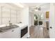 Bright laundry room with modern machines, shelving, and a view of the outdoor patio area at 21 Rivers Point Row # 3C, Charleston, SC 29412