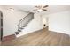 Open-concept living area featuring modern vinyl plank floors, bright lighting, staircase, and doorway to kitchen at 21 Rivers Point Row # 3C, Charleston, SC 29412