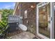 Exterior shot of a brick patio with a sliding glass door and AC unit at 21 Rivers Point Row # 3C, Charleston, SC 29412