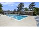 Community pool with blue lounge chairs and a brick clubhouse nearby at 21 Rivers Point Row # 3C, Charleston, SC 29412