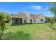A well-maintained backyard with green grass, a screened porch, and an attached home at 217 Smithfield Ave, Summerville, SC 29485
