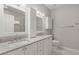 Bathroom with double sinks, granite countertops, white cabinets, and ample lighting at 217 Smithfield Ave, Summerville, SC 29485