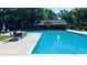 Relaxing community pool area with lounge chairs, tables, and a covered pavilion at 217 Smithfield Ave, Summerville, SC 29485