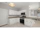 Bright kitchen featuring white cabinets and stainless steel appliances, with eat-in dining space nearby at 217 Smithfield Ave, Summerville, SC 29485