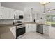 Well-lit kitchen features stainless steel appliances, white cabinets, and views into the living space at 217 Smithfield Ave, Summerville, SC 29485