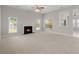 Spacious living room features neutral carpeting, fireplace, and plenty of natural light at 217 Smithfield Ave, Summerville, SC 29485