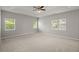 Spacious main bedroom featuring neutral carpet, tray ceiling, and large windows letting in ample light at 217 Smithfield Ave, Summerville, SC 29485