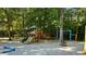 Community playground with swings, slides, and lush trees offering shade at 217 Smithfield Ave, Summerville, SC 29485