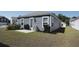 A peaceful backyard showcasing a small patio and tidy landscaping, perfect for outdoor activities at 224 Coral Sunset Way, Summerville, SC 29486