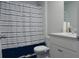 Cozy bathroom featuring white vanity, toilet, and a blue striped shower curtain for a clean and fresh look at 224 Coral Sunset Way, Summerville, SC 29486