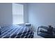 Bright bedroom featuring a bed with a geometric comforter, side table, and a modern TV stand at 224 Coral Sunset Way, Summerville, SC 29486