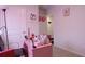 Bright bedroom with pink desk and red accessories perfect for a stylish and comfortable space at 224 Coral Sunset Way, Summerville, SC 29486