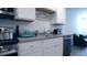 Kitchen featuring stainless steel appliances, white cabinets, and a double basin sink at 224 Coral Sunset Way, Summerville, SC 29486