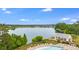 Aerial view of a lake and community amenities featuring a pool, picnic shelter and picturesque scenery at 240 Woodbrook Way, Moncks Corner, SC 29461