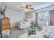 Cozy bedroom with ceiling fan, patterned wallpaper, and ensuite sitting area at 240 Woodbrook Way, Moncks Corner, SC 29461