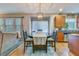 Stylish dining area with an elegant wooden table and a view of the living space and kitchen at 240 Woodbrook Way, Moncks Corner, SC 29461