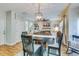 Elegant dining area with a wooden table and chairs, complemented by a modern light fixture and cozy decor at 240 Woodbrook Way, Moncks Corner, SC 29461