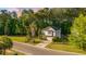 Inviting two-story home featuring a well-manicured lawn and a long driveway leading to an attached garage at 240 Woodbrook Way, Moncks Corner, SC 29461