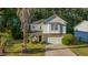 Charming home with a stone-accented base, a well-manicured lawn, and a paved driveway leading to a two-car garage at 240 Woodbrook Way, Moncks Corner, SC 29461
