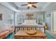 Spacious bedroom with tray ceiling, an iron bed frame, and turquoise rug at 240 Woodbrook Way, Moncks Corner, SC 29461