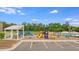 Playground area next to the pool with colorful equipment and nearby parking at 240 Woodbrook Way, Moncks Corner, SC 29461